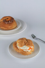 Delicious homemade choux pastry with custard and Marian Plum or Mayongchid. on white background