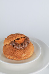 Delicious homemade choux pastry with custard and Marian Plum or Mayongchid. on white background