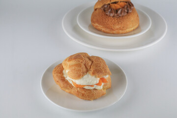 Delicious homemade choux pastry with custard and Marian Plum or Mayongchid. on white background