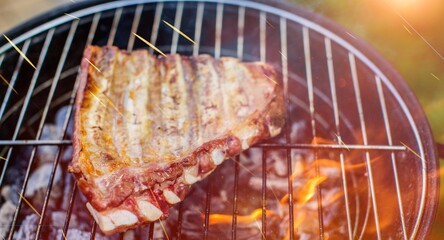 Tasty delicious hot steak preparing on grill rack