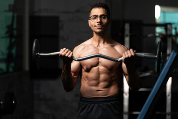 Obraz na płótnie Canvas Man With Gynecomastia Problem Working Out Biceps