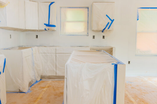 Home renovation kitchen in process of repair finishing works on white paint background