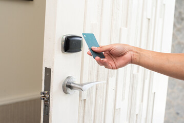 women hand open the Door with keycard