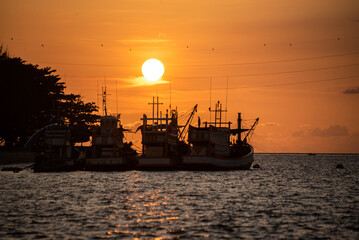 Fototapeta premium Beautiful warm sunset on the sea with fish boat. Beautiful scenery