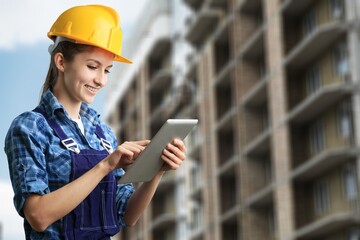 civil engineer looking at digital tablet at construction site