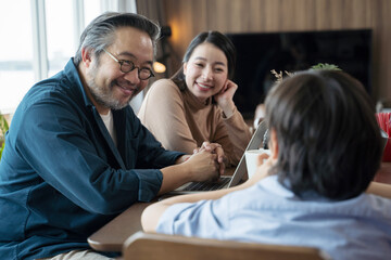 Happy Asian family spending time together in living room. family and home concept.