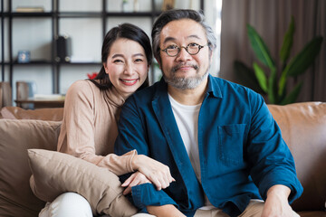 Middle-aged Asian couple smiling for the camera. Family couple portrait