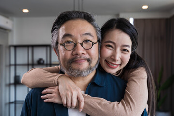 Middle-aged Asian couple smiling for the camera. Family couple portrait