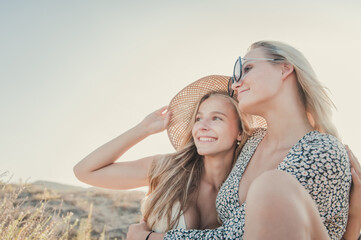 Czech teenagers girlfriends couple enjoy the sunset at a Spanish beach during summer vacations. Moments of complicity between two women who love each other.