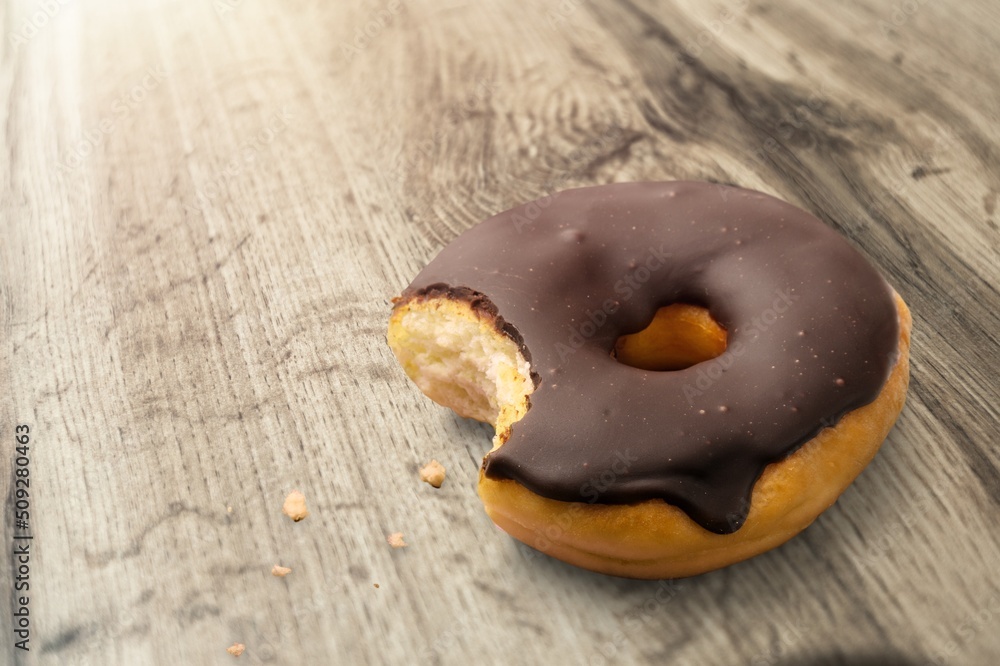 Wall mural tasty sweet chocolate glazed donut with crumbs and creme filled