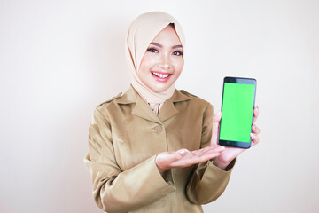 Smiling government worker showing blank screen on a smartphone. A young Asian Muslim PNS wearing...