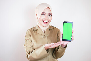 Smiling government worker showing blank screen on a smartphone. A young Asian Muslim PNS wearing...