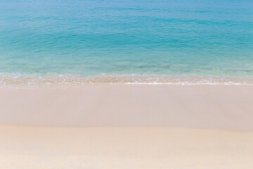 Fototapeta na wymiar Clean fine sandy beach background, tropical beach, summer holiday to the sea