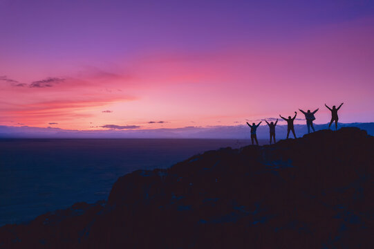 Group Friends tourists stay mountain top and looking sunset. Concept travel trip friendship