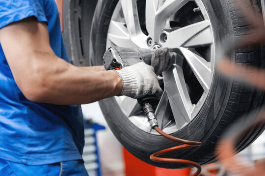 Concept car wheel service. Professional mechanic changing tires