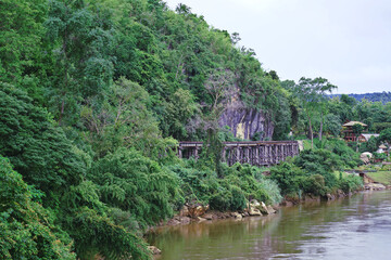 Fototapeta na wymiar Railroad tracks along the hillside by the river.