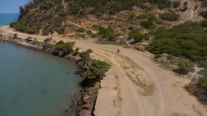 Drone photos of El Morro hill, recorded in the middle of a sunny morning, in the videos you can see, El Morro hill, hills, mountains, coasts, roads, trees on the shore of the beach, beach, rocks, sand