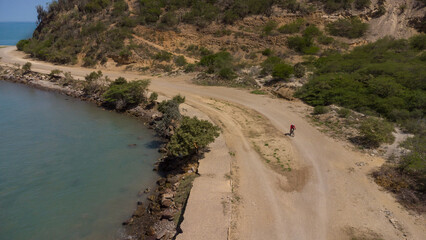 Drone photos of El Morro hill, recorded in the middle of a sunny morning, in the videos you can see, El Morro hill, hills, mountains, coasts, roads, trees on the shore of the beach, beach, rocks, sand