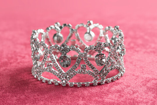 Silver Crown on a Pink Velvet Background