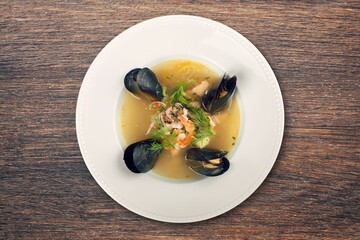 Traditional appetizer fish or chicken soup in plate.