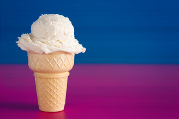 Vanilla Ice Cream Cone on a Bright Blue and Pink Background