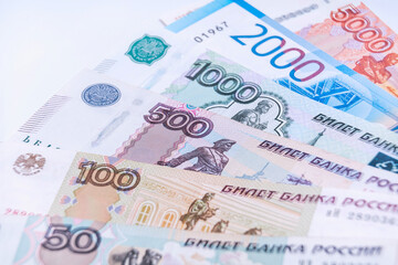 Russian money, banknotes of various denominations lie in a fan, soft focus