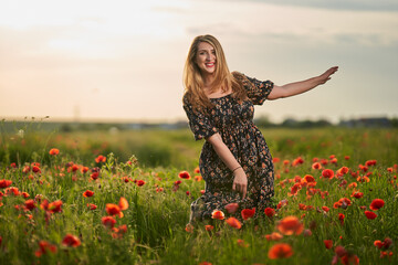 Beautiful plus size woman in a poppy field