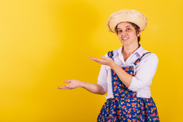 Mature woman dressed in typical Festa Junina clothes. Featuring negative space, product, promotion,...