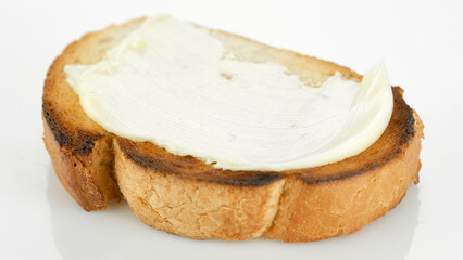 Bread with butter close up on white background