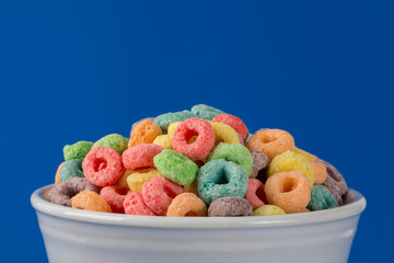 Colorful Fruity Cereal on a Blue Background