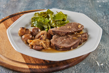 Roast beef with chestnuts and forest mushrooms and green peas. French gourmet food