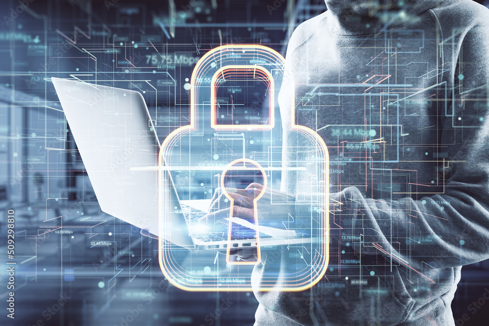 Poster close up of hacker hands using laptop with glowing safety padlock hologram on blurry interior backgr