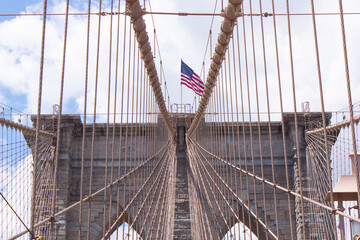 Panoramic view of The Brooklyn bridge and the American flag, New York City. USA.