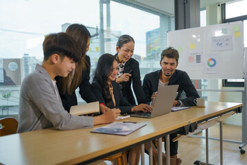 Asian business people planning analyze investment and marketing in office. Business meeting to brainstorm the new project and analysis data document.