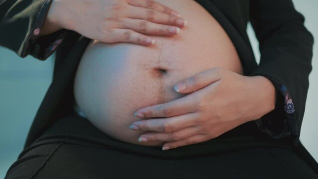 Woman hands touching naked belly. Isolated on light gray background. Emotional loving pregnancy time - 37 weeks. Baby expectation. Side view. Banner. Empty place for text, quote, saying. Closeup.