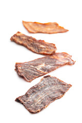 Beef jerky meat. Dried sliced meat isolated on white background.