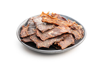 Beef jerky meat on plate. Dried sliced meat isolated on white background.