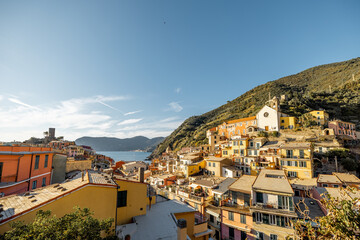 Fototapeta na wymiar Landscape of Vernazza village with colorful old houses and church on the hill at sunny day. Famous village at Cinque Terre National Park at coastline in northwestern of Italy