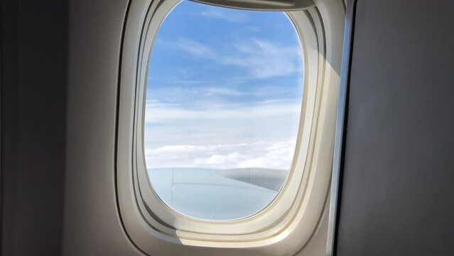 View of clouds and blue sky from airplane window
