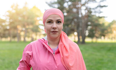 portrait of pretty mature woman, breast cancer survivor with chemotherapy scarf, looking at camera