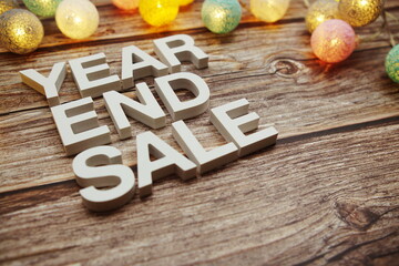 Year End Sale alphabet letters decorate with LED cotton balls on wooden background