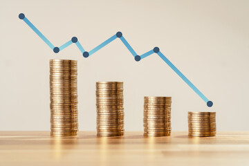 Close up Photo of constantly decreasing coins with arrow on isolated background. Concept of losing...