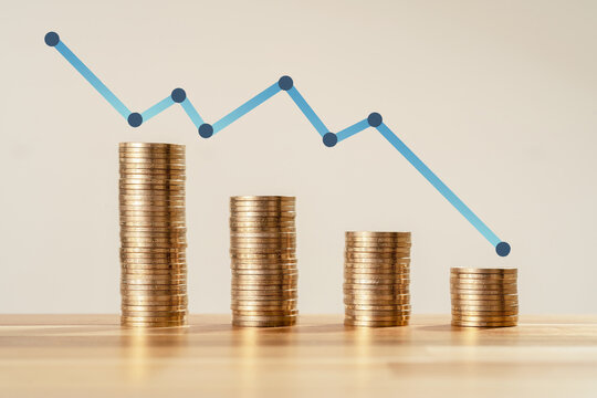 Close up Photo of constantly decreasing coins with arrow on isolated background. Concept of losing money and bankruptcy or failure of new startup.