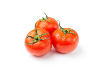 Three red tomatoes with water drops isolated on a white background.