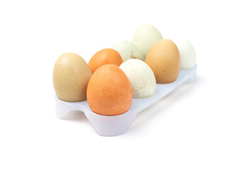 Chicken eggs in plastic basket isolated on a white background. Farm chicken eggs.