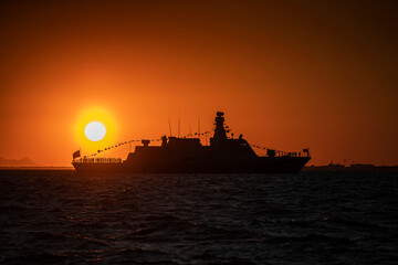 Izmir. Silhouette of a warship on the background of the sunset over the Aegean Sea