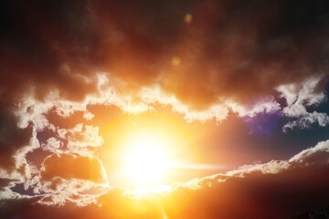 Fototapeta premium Sunlight sun rays shining through clouds in dark.