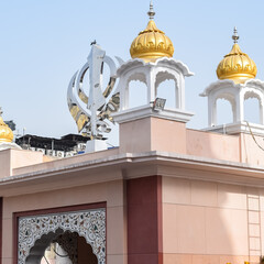 Khanda Sikh holy religious symbol at gurudwara entrance with bright blue sky image is taken at Sis...
