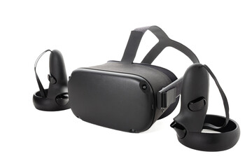 Close-up of a set of virtual reality devices. Joysticks and VR glasses isolated on a white background. Two controllers and a VR helmet. Side view.