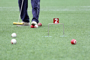 Athlete play gateball game in a field lawn to beat competitors
